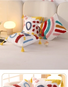Detail of colorful tufted rainbow pillows with yellow tassels on a beige sofa