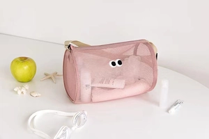 Pink mesh toiletry bag with large eye patches shown with swimming goggles and starfish