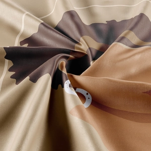 Macro detail of Earth-toned bohemian tapestry fabric showing smooth texture and geometric patterns