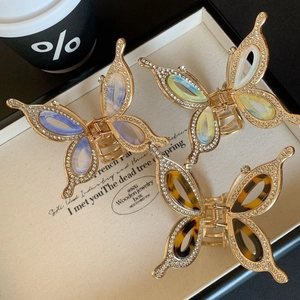 Elegant gold butterfly hair claws with rhinestones in diverse colors in a gift box
