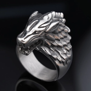 Macro shot of vintage steel wolf head ring detailing intricate fur textures and carvings