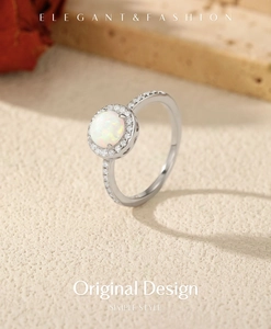 Detail of silver S925 ring with white opal center stone and halo of tiny diamonds