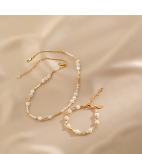 Baroque freshwater pearls and golden beads necklace set on champagne silk fabric