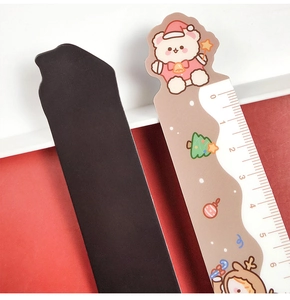 Detail showing the magnetic back and front of a cartoon Christmas bear ruler for students