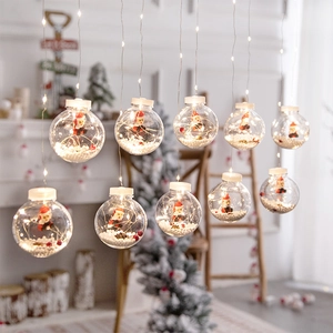 Christmas tree hanging lights with Santa figures and warm LED bulbs in transparent globes