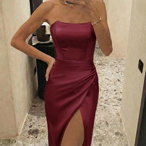 Detail view of the high side slit on an elegant burgundy satin strapless formal dress