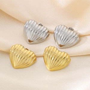 Detailed view of 18K gold and silver plated heart stud earrings with wavy 3D texture