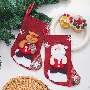 Christmas burlap stockings with Santa and Reindeer appliques on a white festive background