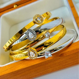 Polished stainless steel bracelets with teardrop, heart, and round cubic zirconia stones