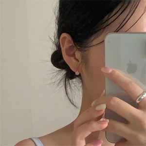 Mirror selfie showing 925 silver cat-eye stone earrings and minimalist silver ring on finger