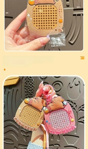 Close-up of cute pink and brown capybara squeeze toy keychain with metal ring