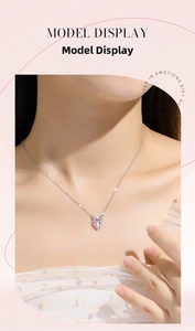 Close-up of 925 silver heart necklace with pink gradient stone and crystal bow on model
