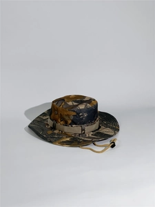 Detail of outdoor tactical boonie hat with breathable metal vents and camouflage pattern