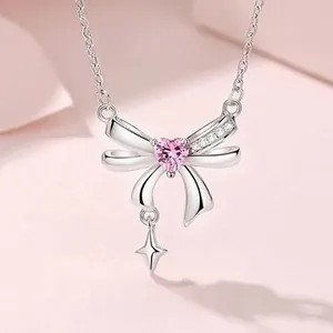 Detailed macro view of S925 silver necklace with pink heart gem and star pendant