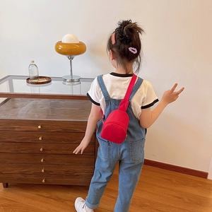 Minimalist red canvas chest bag for children with adjustable strap and zip closure