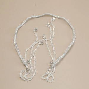 Detail of silver beaded headband with crystals and detachable tassel chain jewelry