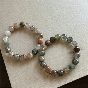 Macro shot of multi-colored rutilated quartz beads showing natural crystal textures