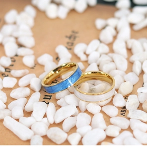 Detail of blue and white enamel rings on decorative stones with a vintage aesthetic