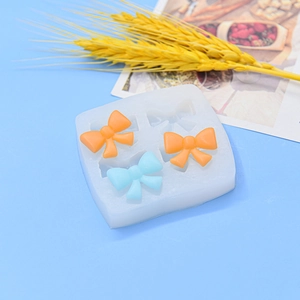 DIY silicone bow mold for fondant and resin crafts with colorful finished bow charms