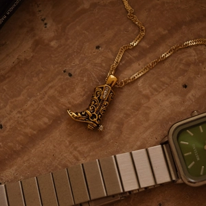 Vintage gold cowboy boot necklace with floral engraving and rhinestone details