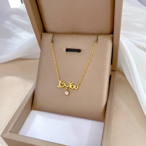 Elegant gold zircon necklace with round diamond pendant displayed in a premium gift box