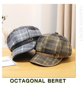 Detailed texture of woolen plaid octagonal berets with leather strap and metal buckle