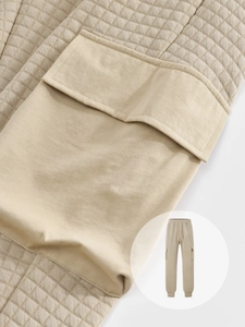 Close-up of beige men's cargo sweatpants showing waffle texture fabric and utility pocket