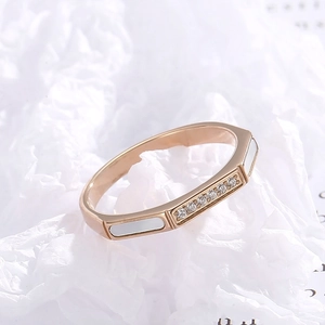 Macro detail of rose gold octagonal ring with shell inlay and micro-pave crystals