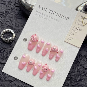 Handmade press-on nails featuring 3D pink pigs and hearts with soft gradient finish