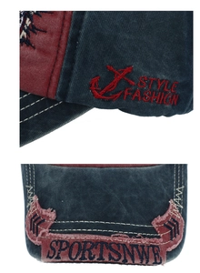 Detail of red anchor embroidery and vintage distressed fabric on navy baseball cap
