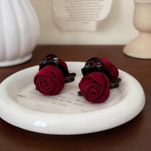 Retro wine red rose hair claws set in a ceramic plate for elegant vintage hairstyles