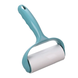 Ergonomic teal lint roller with white sticky paper for clothing and home fabric cleaning