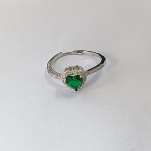 Detail view of adjustable silver ring with green heart-shaped zircon and pave crystals