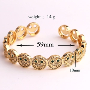Detailed view of golden smile bracelet with green and white zircons and size markings