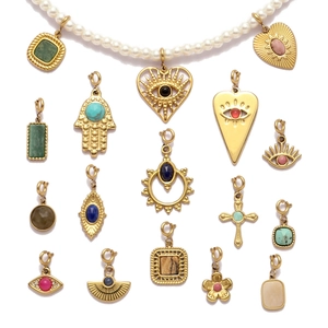 Vintage stainless steel heart and evil eye stone pendants on pearl necklace display