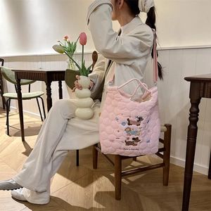 Pink quilted crossbody bag featuring cute dog embroidery and a large bow detail