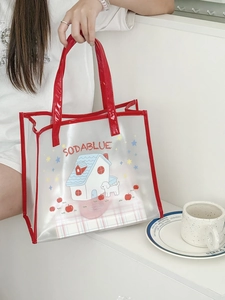 Detail of transparent PVC tote bag with red handles and cute cartoon dog print