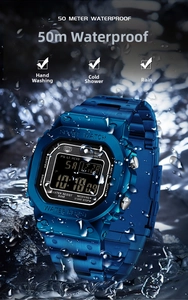 Blue digital sports watch with 50m water resistance shown amidst splashing water