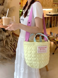 Quilted heart pattern tote bag in yellow with purple shoulder strap and blue handle