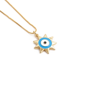 Gold plated starburst pendant necklace with blue evil eye on a classic box chain