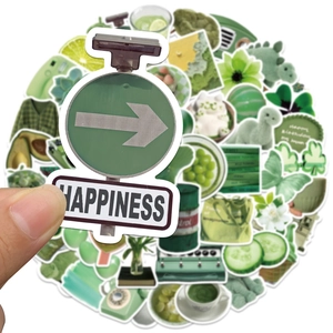 Close-up of green happiness sticker being held against a collection of cute doodle decals