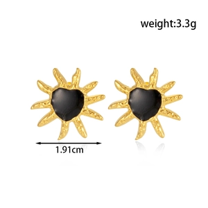 Golden sunburst stud earrings with black heart center and polished metallic rays