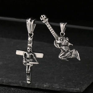 Close-up of vintage rock skeleton guitar pendants in antique finish stainless steel