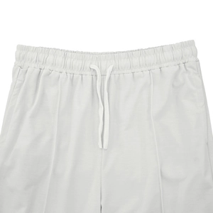 Close-up of the elastic waistband and white drawstring on knitted casual joggers