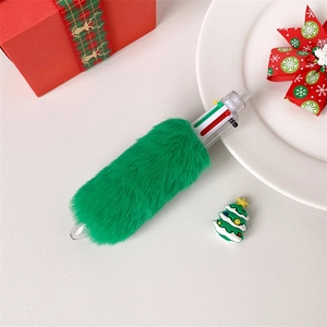 Detail of multi-color Christmas ballpoint pen with green faux fur in a festive gift setting