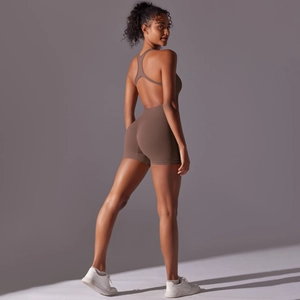 Macro detail of brown seamless ribbed fabric and backless halter design on jumpsuit