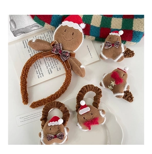 Detail of plush gingerbread man headband and hair clips with festive Christmas ornaments