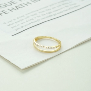 Macro detail of gold S925 silver double-layered ring with sparkling white zircons