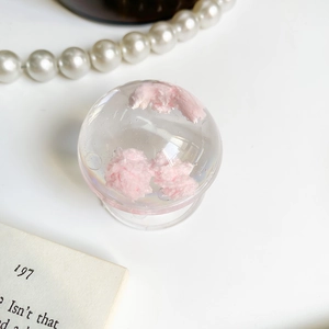 Detail of a transparent crystal ball phone socket with soft pink cloud-like filling