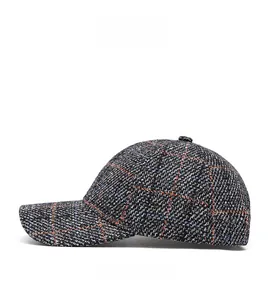Detailed side view of a plaid baseball cap with grey, orange and blue woven fabric